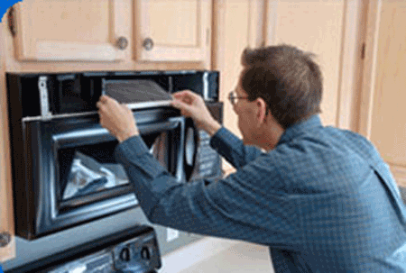 technician working on a microwave oven